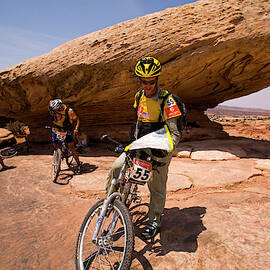 Team Checking A Map While Mountain by Corey Rich