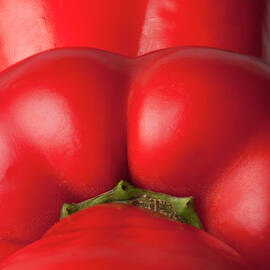 Three Red Bell Peppers Arranged In A Row by Larry Washburn