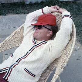 Truman Capote Leaning Back In A Chair by Horst P. Horst
