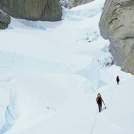 Two Climbers Approach The Sw Pillar by Andrew Querner