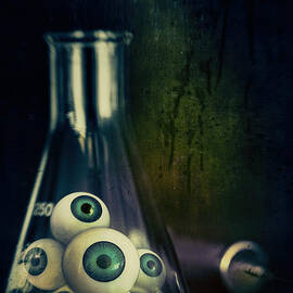 Eyeballs in lab beaker with needles by Sandra Cunningham