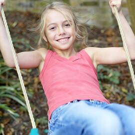 Girl Playing On A Swing