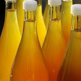 Apple juice in bottles by Matthias Hauser