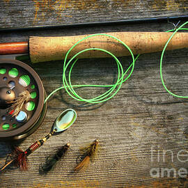 Fly fishing rod with polaroids pictures on wood by Sandra Cunningham