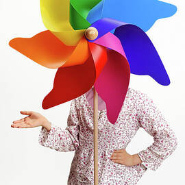 Girl behind a colorful windmill by Sami Sarkis Photography