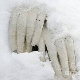 Hands of a statue covered with snow by Matthias Hauser