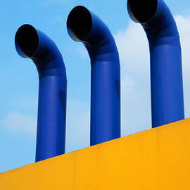 Three chimneys on yellow wall by Sami Sarkis Photography