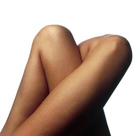 Top View Of The Tightly Crossed Legs Of A Woman