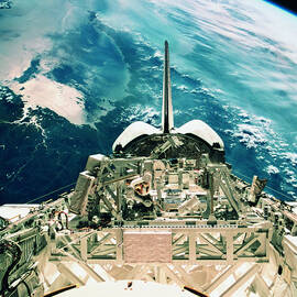 View Of The Tail Section Of The Space Shuttle Orbiting Above Earth by Stockbyte