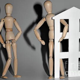 Wooden mannequin couple with a house shape by Sami Sarkis Photography
