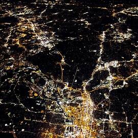 flying at night over cities below by ALEX GRICHENKO
