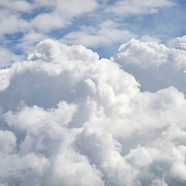 Dramatic cumulus clouds with high level cirrocumulus clouds for  by Matthew Gibson