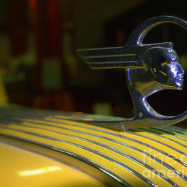 antique 1936 Pontiac Indian hood ornament on yellow car by Charlene Cox
