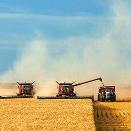 Combines and Tractor Working Together by Todd Klassy