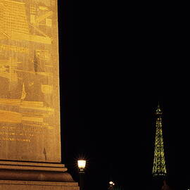 Luxor Obelisk in the Concorde Plaza with view of the Eiffel Tower illuminated at night by Sami Sarkis Photography