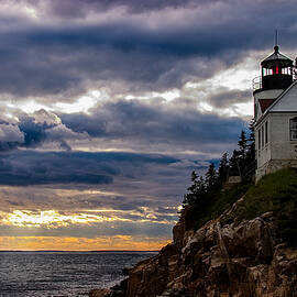 Rocky cliffs below Maine lighthouse by Jeff Folger