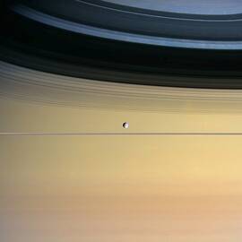 Saturn And Its Moon Dione by NASA/Science Source