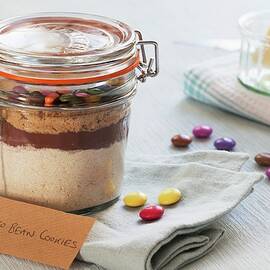 A Preserving Jar Containing The Dry Ingredients For Making Chocolate Biscuits With Chocolate Beans by Lowe, Cath