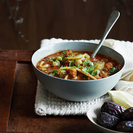 Harira Soup In Bowl With Dates And Lemon Wedge by Brett Stevens