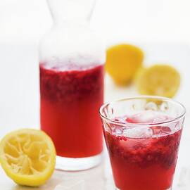 Raspberry Lemonade With Lemon Juice And Ice Cubes by Hein Van Tonder