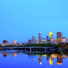 Blue Minneapolis downtown with reflection in Mississippi river by Alex Nikitsin