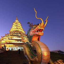 Temple in Chiang Rai at dusk, Thailand by Alex Nikitsin