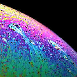 Macro Shot Of A Soap Bubble Simulating A Planet by Cavan Images