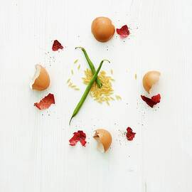 A Clock Face Made From Eggshells And Onion Skin With Hands Made From Green Beans Resting On Orzo Pasta by Michael Wissing