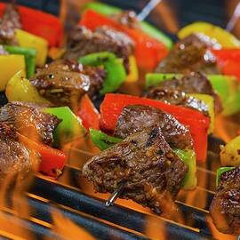 Beef Skewers With Peppers On A Flaming Barbecue by Brian Enright