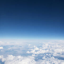 Blue Sky Over Clouds, Aerial View by Roger Wright