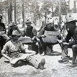 Camp Scene Where Solidiers Read Newspape by Bettmann