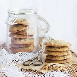 Chocoate Chip Cookies In A Storage Jar And Next To It by Tamara Staab