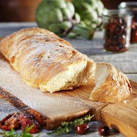 Ciabatta Bread On An Olive Wood Board by Niklas Thiemann
