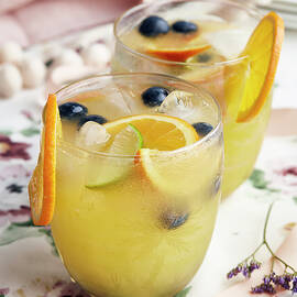 Cocktails With Orange Slices, Berries And Ice Cubes by Debby Lewis-harrison