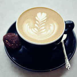 Cup Of Coffee With Leaf Pattern Froth by Jake Curtis