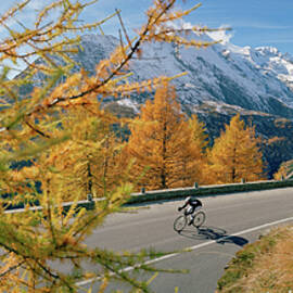 Cyclist Along Snow Covered Mountains by Giovanni Simeone