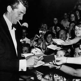 dean martin signing autographs by Globe Photos