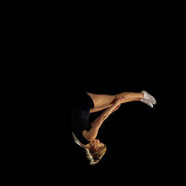 Female Gymnast Upside Down Mid Flight by Peter Muller