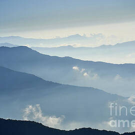 Fog above mountain in valley Himalayas mountains by Raimond Klavins