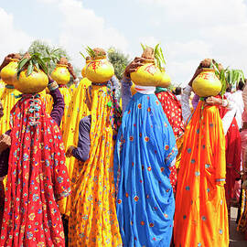 Group Of Colourfully Dressed by Grant Faint