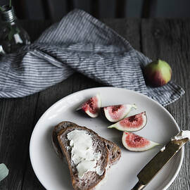 High Angle View Of Breads And Cream With Fig In Plate On Table by Cavan Images
