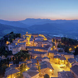 Italy, Emilia-romagna, Rimini District, Pennabilli, View Of The Village From The Ruins Of Billi Castle At Dusk by Franco Cogoli