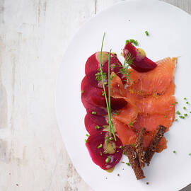 Marinated Salmon Trout With Beetroot And Spiced Bread Strips On Plate, Overhead View by Jalag / Jan-peter Westermann