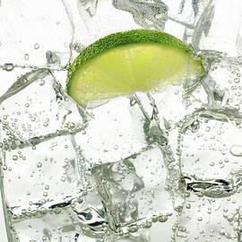 Mineral Water With Ice Cubes And A Slice Of Lime by Frank Adam