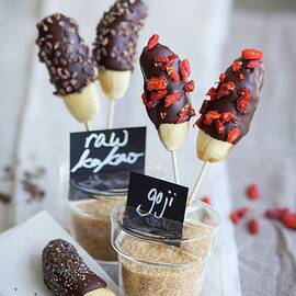 Mini Bananas With A Chocolate Glaze, Raw Cocoa Nibs, Chia Seeds And Goji Berries superfood by Eising Studio