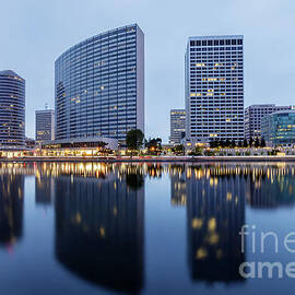 Oakland skyline panoramic view with Lake Merritt Reflections at blue hours by Yuval Helfman