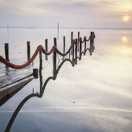 Old Wooden Port Submerged At Sunrise by Cavan Images