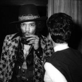 portrait of jimi hendrix drinking alcohol backstage by Globe Photos