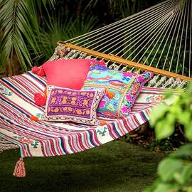 Pouffe Below Cushions With Ethnic Patterns In Hammock In Exotic Garen by Winfried Heinze
