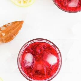 Raspberry Lemonade With Lemon Juice And Ice Cubes by Hein Van Tonder